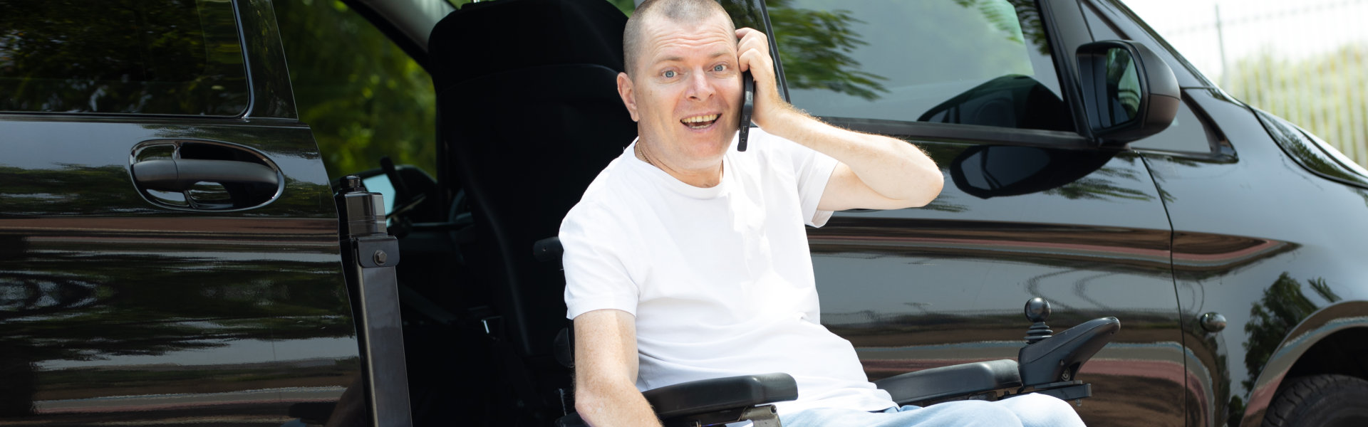 man on wheelchair standing on the car lift