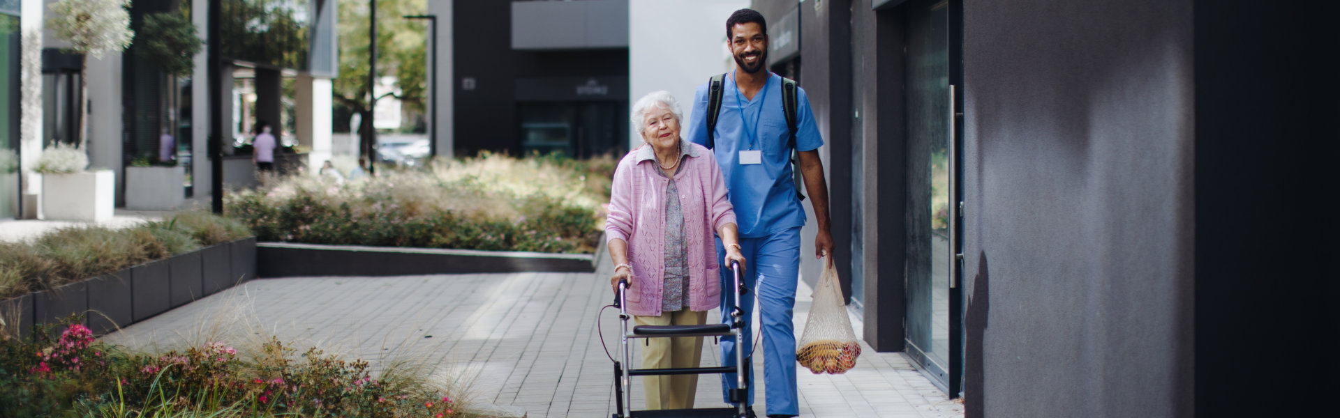 nurse is helping thwe senior woman with rollastor